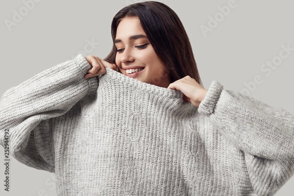Obraz Beautiful brunette woman in sweater posing in studio