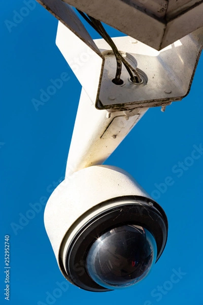 Obraz Modern CCTV camera on a clear blue sky background