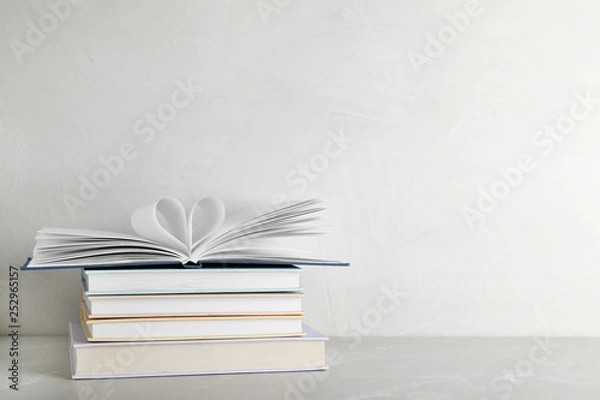 Fototapeta Stack of hardcover books on table against white background, space for text
