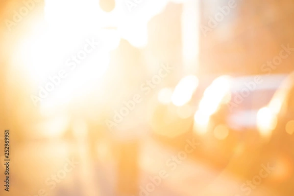 Fototapeta Abstract blurred yellow background with sun light and people with transport