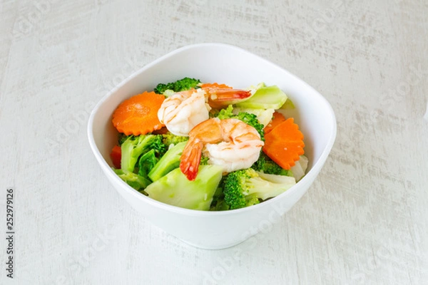 Fototapeta Stir fried broccoli with shrimp on white background.