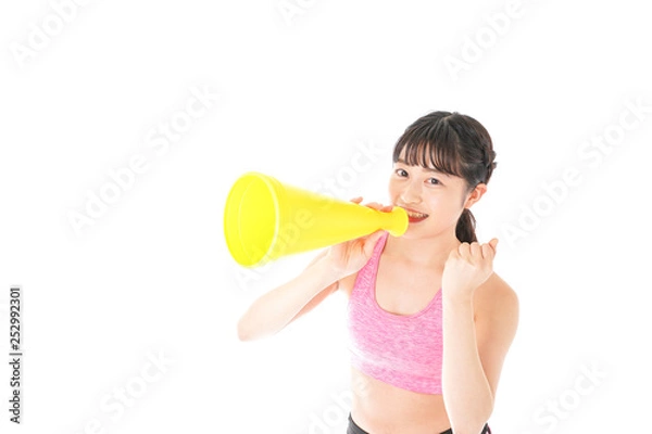 Fototapeta スポーツウェアで応援する若い女性