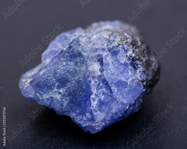 Obraz Soft blue violet rough TANZANITE from Tanzania isolated on black background.