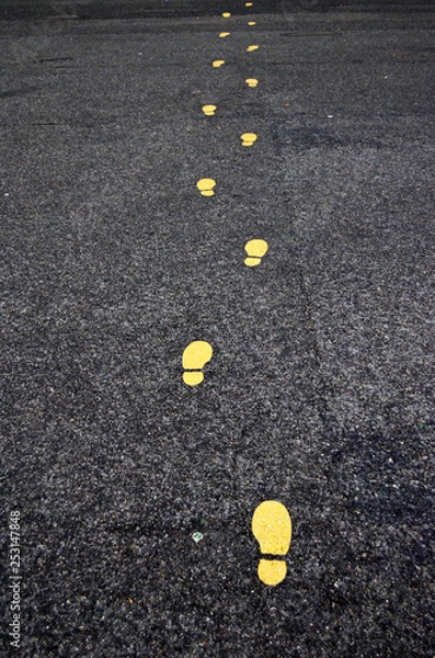 Obraz Yellow footprints painted on asphalt in Vienna, Austria