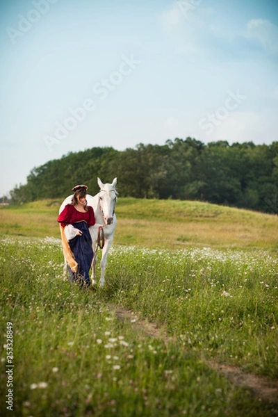 Fototapeta Medieval Princess with a White Horse in a Meadow - Room for Text