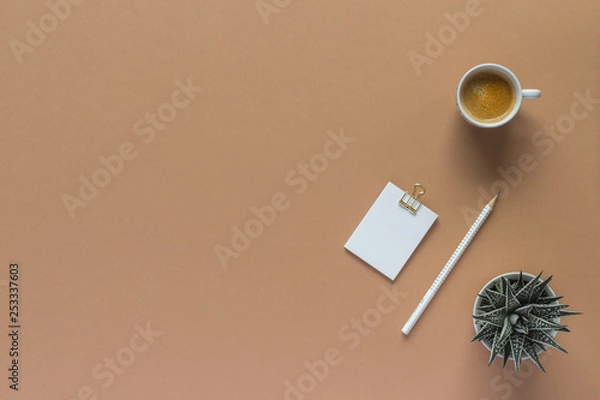 Fototapeta pencil notepad beige workspace plant coffee cub  top view with copy space for your text. flat lay. 