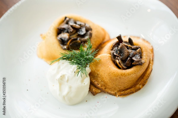 Fototapeta baked pancakes with mushrooms and sour cream