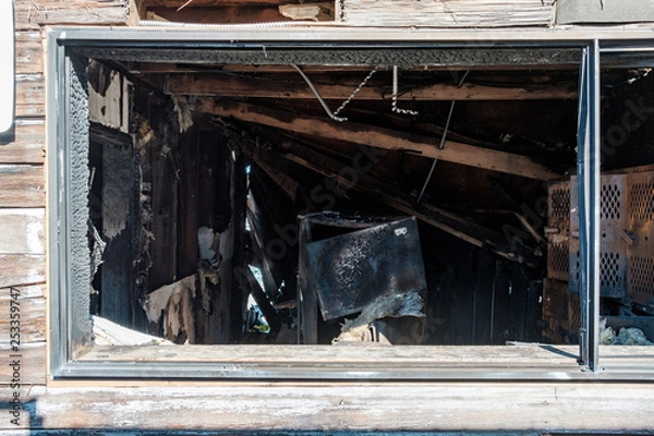 Fototapeta Looking through a window of a burned out building
