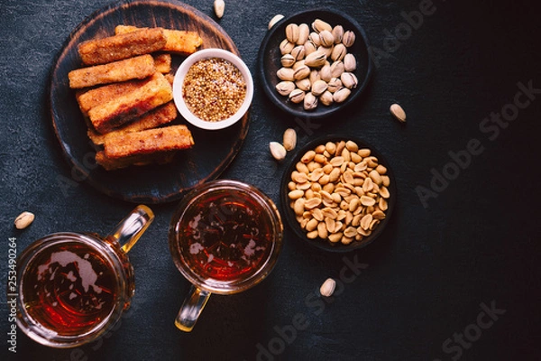 Fototapeta beer and snacks. bar table. restaurant, pub, food concept. craft lager drink, salted nuts and breaded fried cheese. friday party atmosphere, craft brewery background