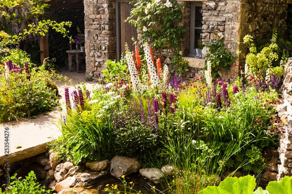 Obraz Decorative garden with a patio area in a countryside
