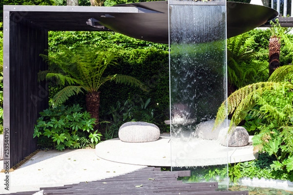Obraz Patio area with a waterfall in a beautiful garden