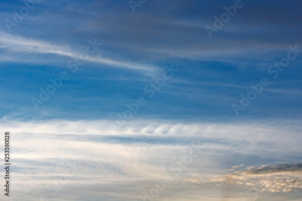 Fototapeta Kelvin, Helmholtz instability clouds wavy on blue sky, feathery curls