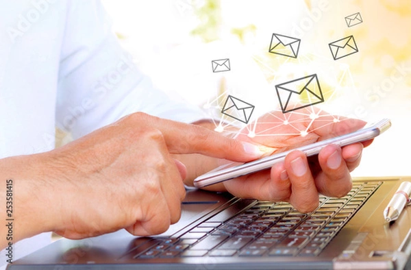 Obraz Businessman using a mobile phone with email application.