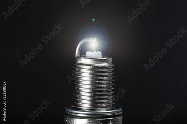 Obraz working spark plug with blue sparkle