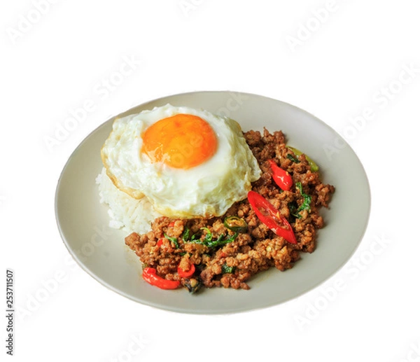 Fototapeta Rice topped with stir fried pork and basil on white background.