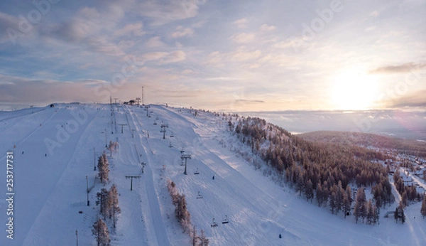 Fototapeta Aerial view of one of the ski slopes in Idre Fjall, Sweden during an early morning sunrise a cold winter day. 