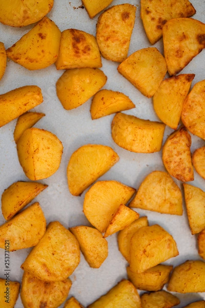 Fototapeta Close up of baking tray with Patatas Bravas, a traditional Spanish tapas dish, potato cubes or wedges roasted, baked or deep fried until tender and cripsy on the outside