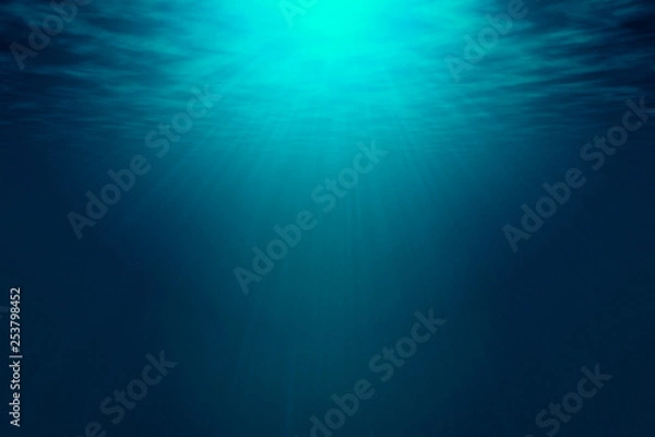 Fototapeta Deep blue sea with rays of sunlight, ocean surface seen from underwater. Background texture with copy space for text or product display.