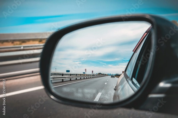 Fototapeta look in the rear view mirror of a car