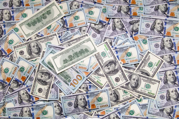 Fototapeta One hundred dollar bills on the table as background