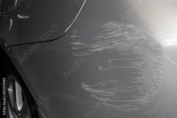 Fototapeta A gray car with scratch of accident