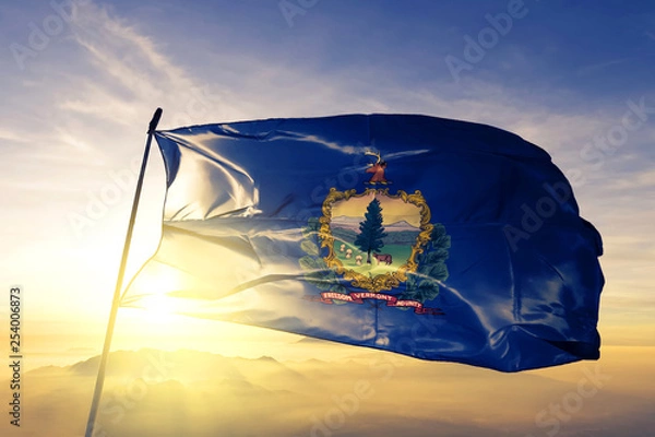 Fototapeta Vermont state of United States flag waving on the top sunrise mist fog