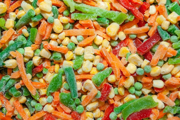 Fototapeta a mixture of frozen vegetables: corn, peas, carrots and paprika, background, texture