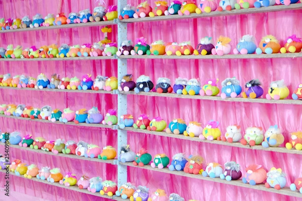Fototapeta Perspective view of many dolls in multiple rows on the shelf