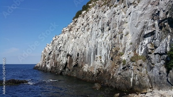 Fototapeta Jons Kapel is an extremely impressive rock formation. A tall, granite cliff located on the west side of the Danish island of Bornholm. Apparently he took his name from the name of monk Jon.