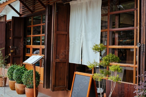 Fototapeta A front of restaurant or cafe Japan style, decorative with white fabric and menu tray.