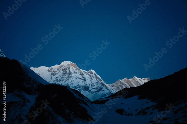 Fototapeta White peak Annapurna on a background of blue sky. Himalayas. Nepal