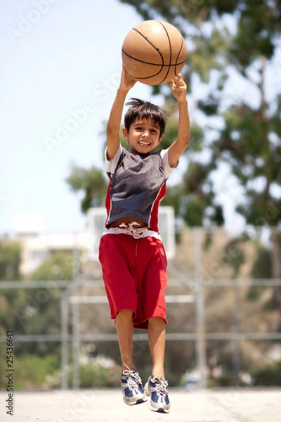 Obraz Young basketball player jumping high