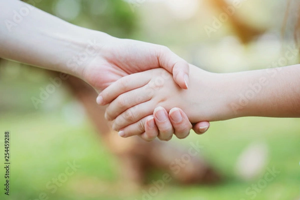 Fototapeta Close up at the hands two teenage girls. Show unity as a collaborative work together. To succeed, one has to understand each other in communication. Concept International Women's Day