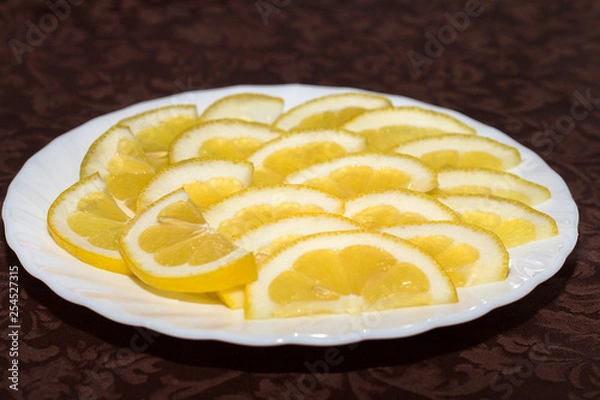 Fototapeta lemon slices on a white plate