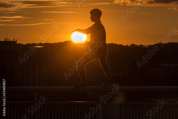 Fototapeta silhouette of a man at sunset
