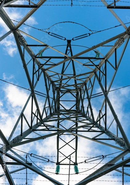 Obraz Looking up at electricity power lines, cloudy blue sky background