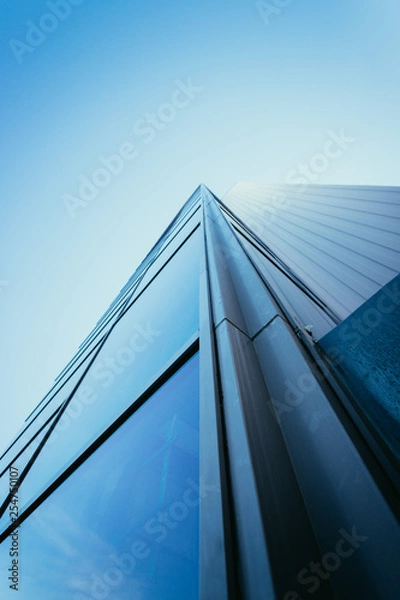 Fototapeta Modern skyscraper out of glass and blue sky