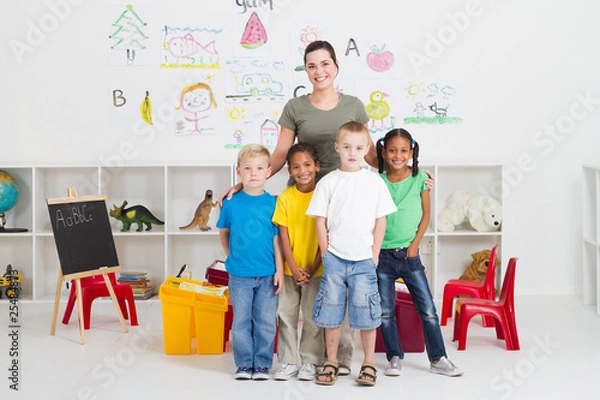 Fototapeta pretty teacher with happy kindergarten kids