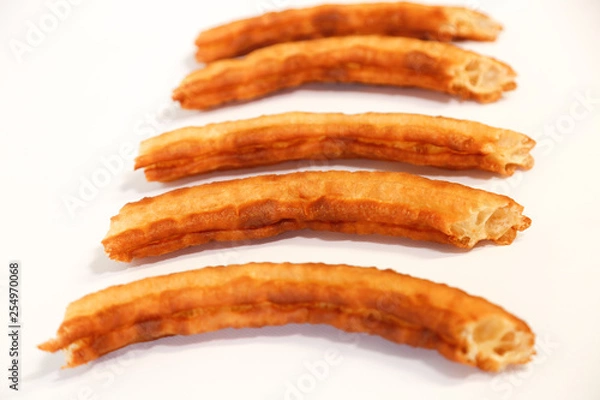 Fototapeta spanish fritters on white background