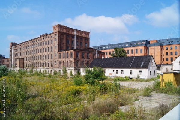 Fototapeta Old  abandoned factory, old architecture of the city of Łódź - historic factories in Łódź - details of industrial architecture