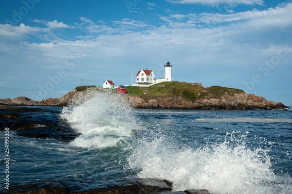 Fototapeta Waves Break Around Nubble Lighthouse on a Summer Day in Maine