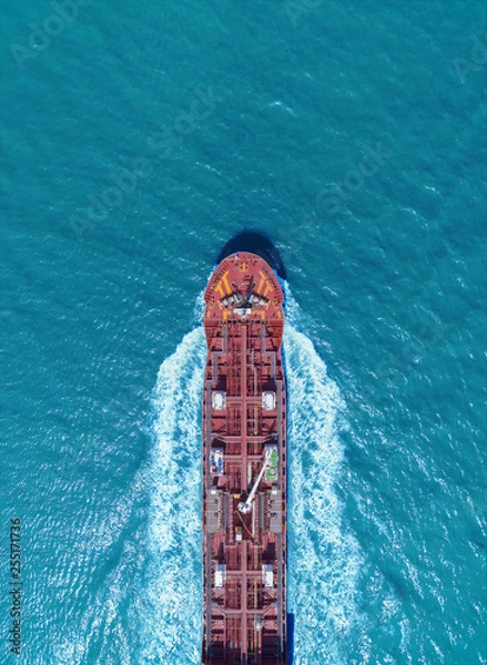 Obraz Aerial top view Oil ship tanker full speed with beautiful wave transportation from refinery on the sea.
