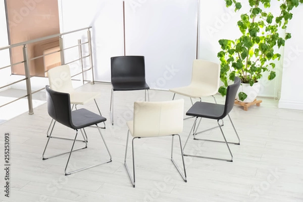 Fototapeta Empty chairs prepared for group psychotherapy session indoors