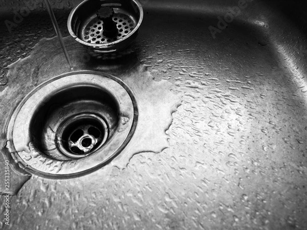 Fototapeta Close up of sink drain with water droplets