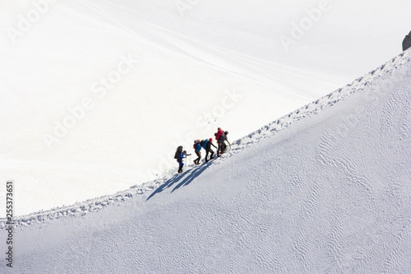 Obraz Climbing a group of climbers on a snow-covered ridge. Close-up