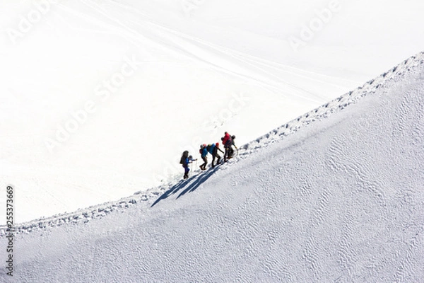 Obraz Climbing a group of climbers on a snow-covered ridge. Close-up
