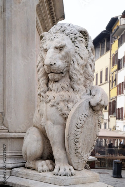 Fototapeta Stone lion holding shield outside of the of Basilica of Santa Croce (Basilica of the Holy Cross) in Florence, Italy