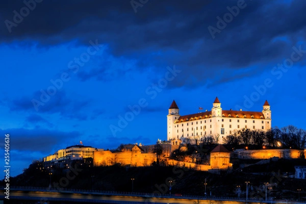 Fototapeta night view of Bratislava castle from river surface with dramtic sunset skyline