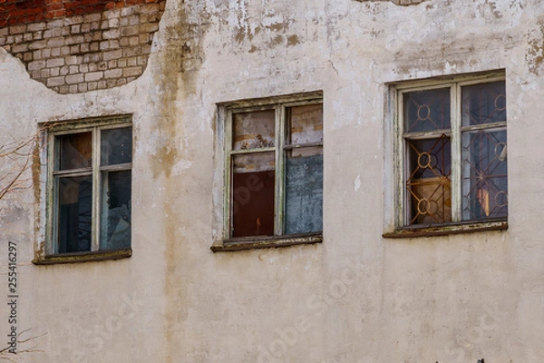 Fototapeta windows in a brick house with a bare facade