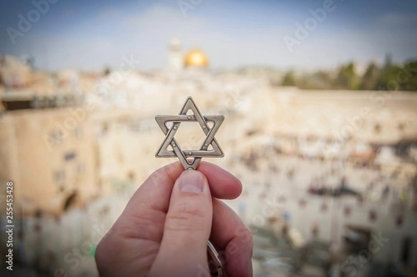 Fototapeta JERUZALEM, IZRAEL. 15 lutego 2019 r. Dłoń trzymająca gwiazdę Dawida, żydowski symbol religijny przy zachodniej ścianie świątyni żydowskiej na Starym Mieście w Jerozolimie. Judaizm Obraz koncepcji syjonizmu.
